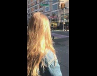 Man on scooter sings into speaker as he drives around