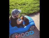 Baby drives blue toy car that bounces like a lowrider