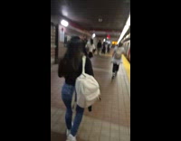 Woman carries bull head walks at station