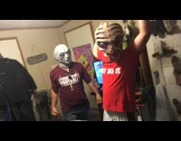 Two guys with alien masks on shaking head