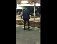 man dancing on edge of train ledge