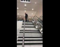 Guy walks down stairs plays piano 