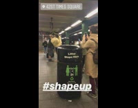 Hairstylist in fur jacket cuts mans hair in the middle of subway station