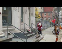 Altercation between small elf man and guy in santa outfit