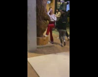 Woman poses with the bear statue at a party