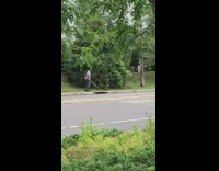 Guy rides hoverboard while cutting weeds gardening 