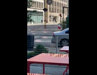 Woman in yellow dress raise hands beside the stoplight