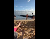Woman bikini sits for photo at beach