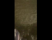 Pedestrians walk in flooded water 