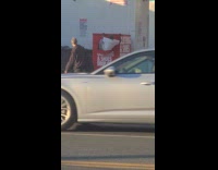 Man climb out from clothing drop off box