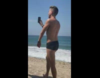 Shirtless guy black speedo selfie beach sand