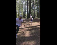 Woman pushes guy over to catch football