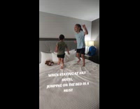 Kids jumping on hotel bed
