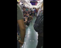Guy dances with heelie shoes and rolls back and forth on subway train