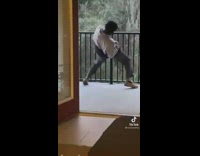 Guy doing funny stanky leg dance on railing