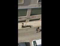 Pink shirt girl black pants walks alley