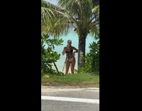 Woman in bikini tiktok dance between the palm trees