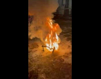 Flame on ground produce curved black solid substance