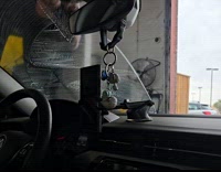 Filmer records man clean car front windshield