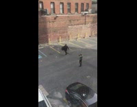 Guy black costume cape spin parking lot