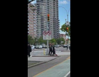 Man standing on road divider plays the trumpet 