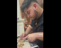 Man Cuts Snacks to Make Windmill for Gingerbread House