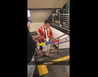 Live band plays drums in red yellow blue sticks while walking up subway station stairs