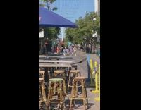 Girl dancers on street wooden chairs umbrella