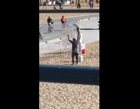 Woman in white dress poses beside the bubble blower