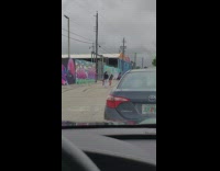 Three women tiktok twerk in the middle of the street