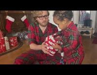 Baby throws christmas present ball at dad