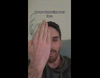 Guy covers face and reveals face deformity