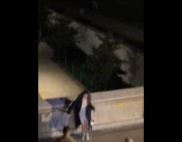 Woman in dress dances Eiffel tower behind