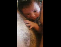 Newborn baby touches and feel chest hair