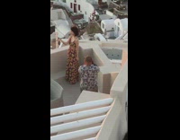 Girl floral dress hold sunset Santorini Greece