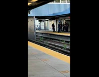 Man dances by himself next to group of cops