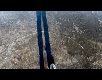 Man walking on frozen water and cracks