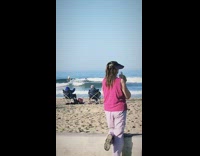 Collab Kook Of The Day - Pink Shirt Woman Blows Conch Shell On Beach