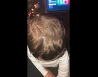 Baby blue eyes looks up at camera and smiles