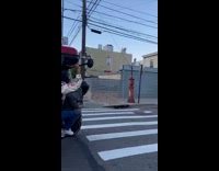 Guy on motorcycle carries grill over head 