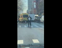 woman blocks crosswalk to dance in street