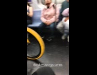 Old man with bicycle inside subway train