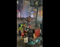 Guy wears a lot of stuffed toy 