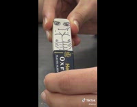 Person pulls back eraser cover to reveal drawn on body