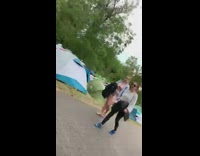 Drunk guy tackles black trash can at camp site with tents