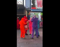Group in red blue purple suits dance