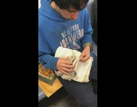 New York Islanders blue sweater guy sifting through old book pages