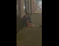 couple making out on the floor street