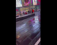 Woman in bikini poses in the cold Times Square