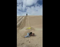 Woman falls off while sledding on sand 